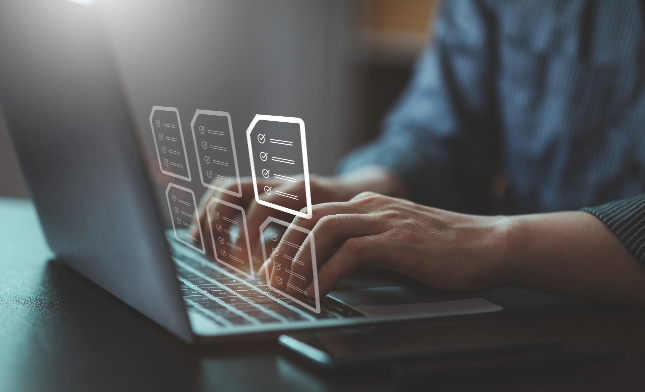 Person using a laptop with graphic overlays illustrating task management or workflow process.